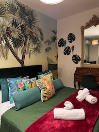 First room we stayed in at the B&B. AC and fridge with breakfast treats and coffee included. Spacious shower.