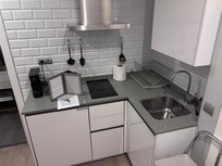 Full kitchen with washer/dryer, fridge, microwave, stove top, coffee and tea