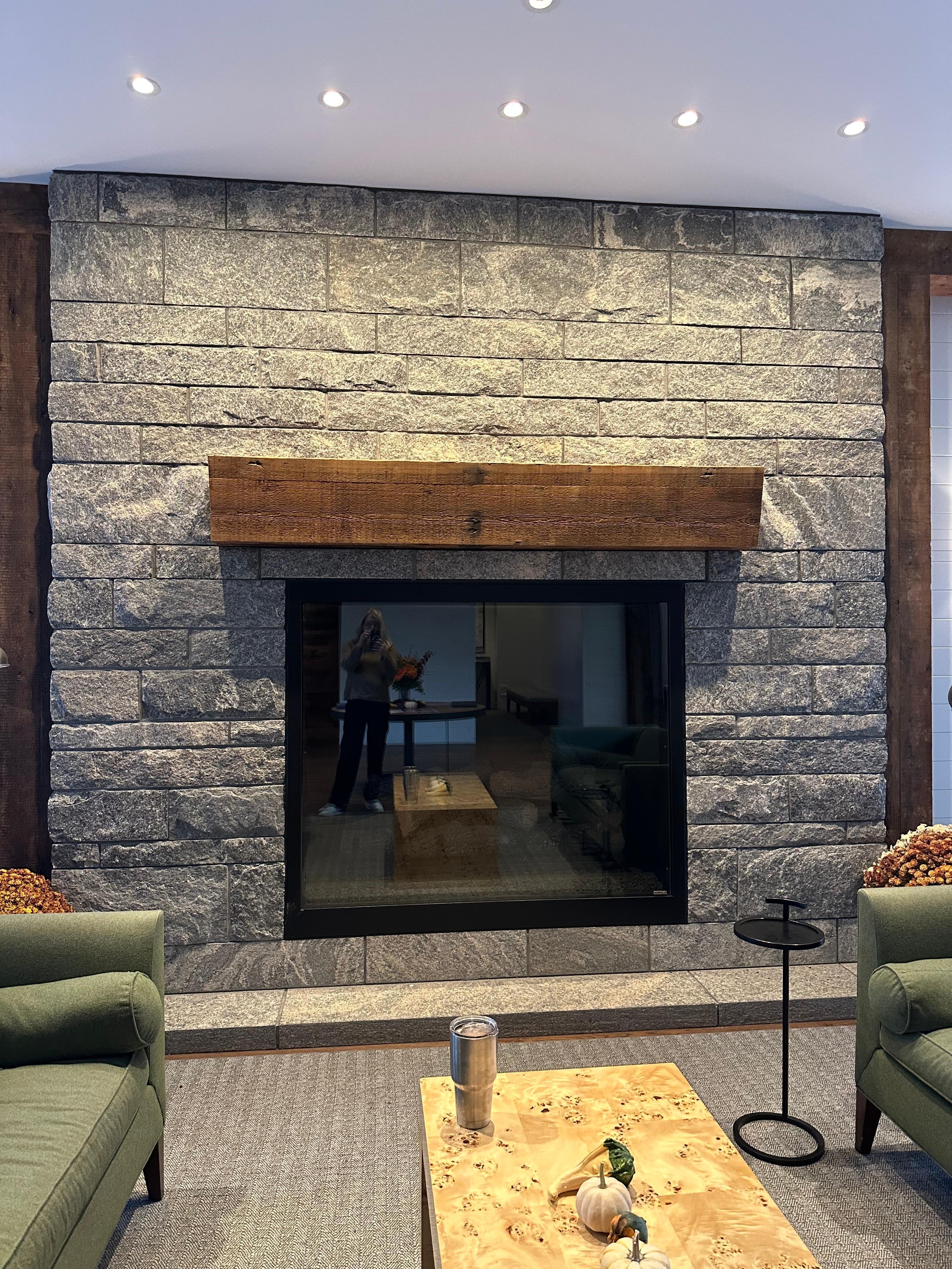 A large fireplace in the cozy lobby