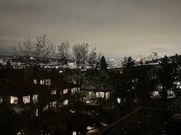 View to NE at night of Hwy99 Bridge and Seattle lights on the other side of Lake Union.