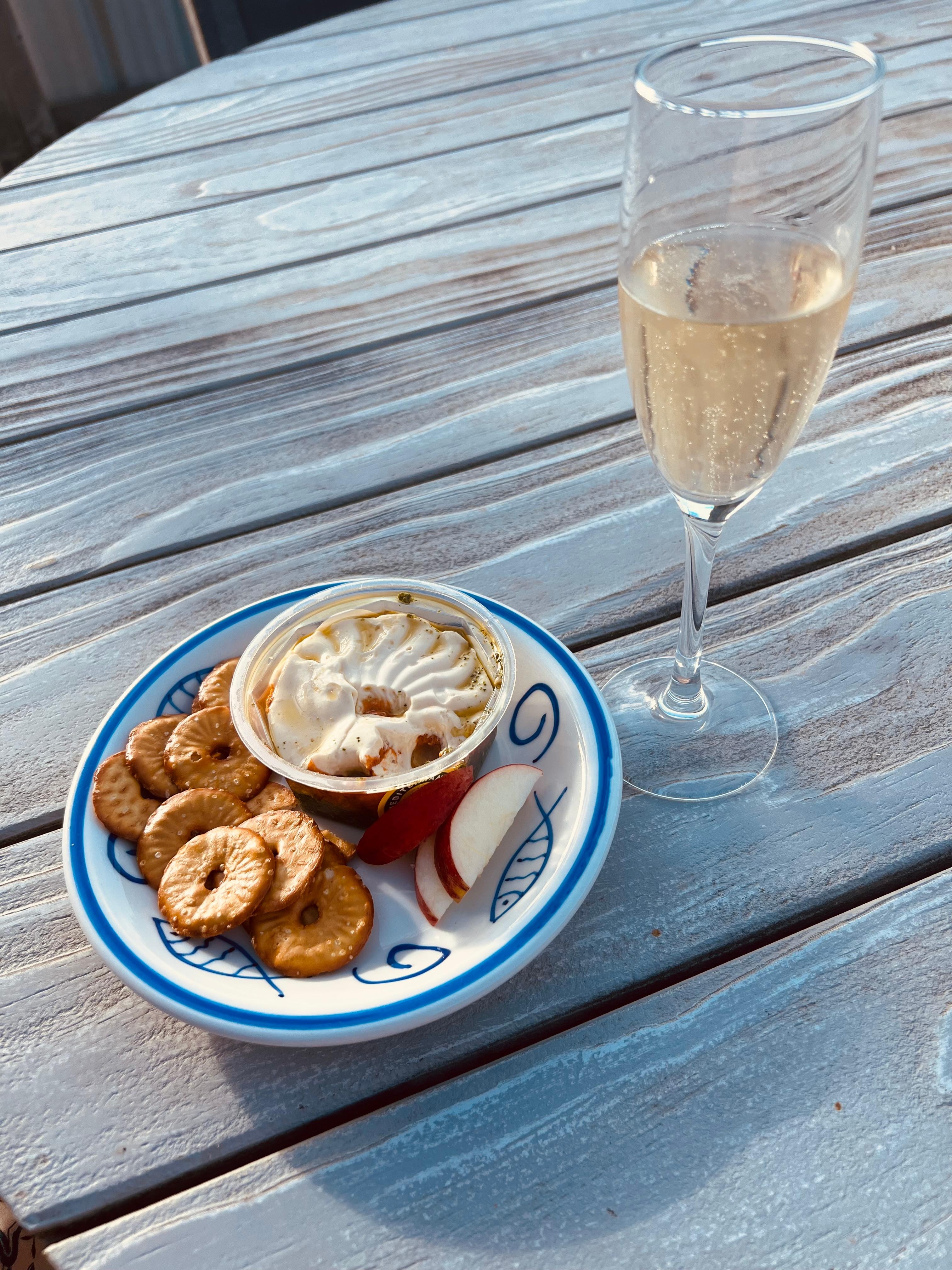Having Snacks and bubbles )all from the local Four Square) out on the deck while the kids are at the beach ☺️