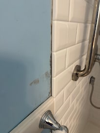 Shower coming away from the wall with mold