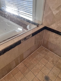 Upstairs master bath shower missing tiles and mold growing. Smelly too.