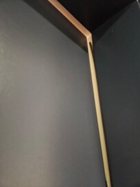 Closeup of gap of door into hotel room 321 from hallway