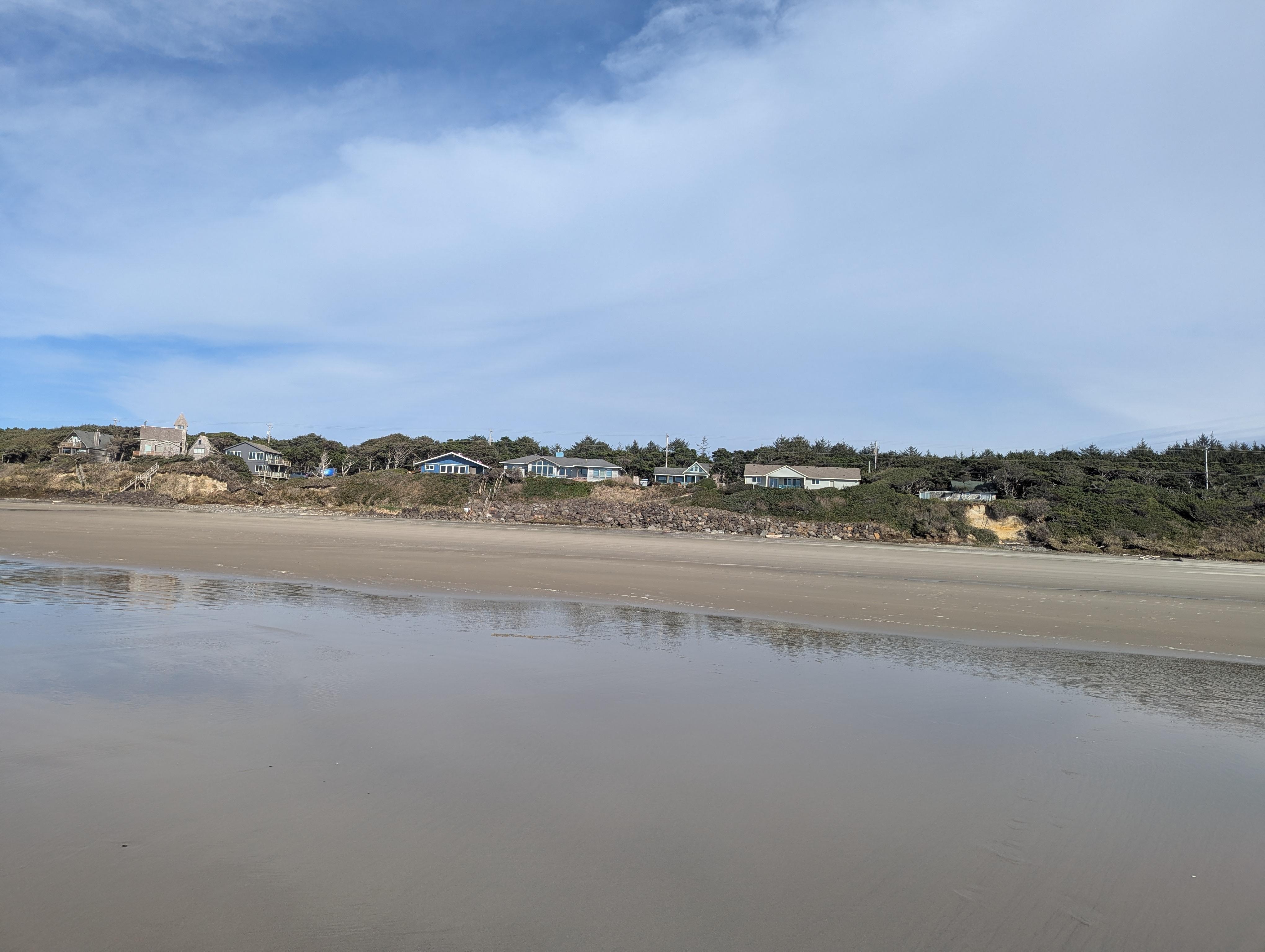 View of the cottage and other surrounding homes from down on the beach 
