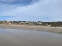 View of the cottage and other surrounding homes from down on the beach