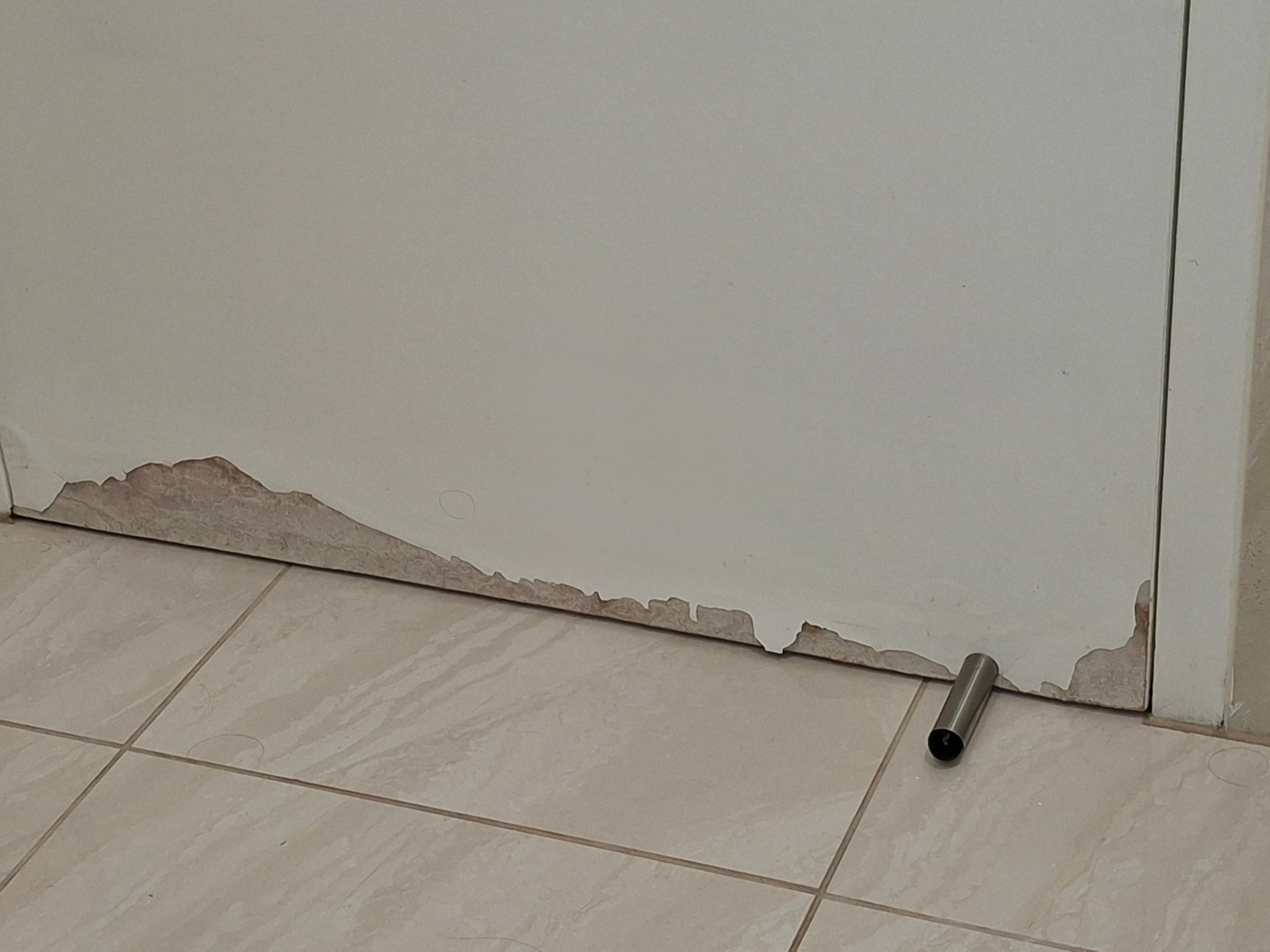 Damage on bathroom door because of the amount of water that leaks from the shower 