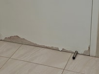 Damage on bathroom door because of the amount of water that leaks from the shower