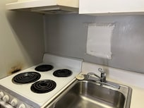 Burned wall broken burners and torn painted-over sign…?