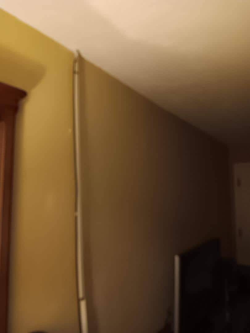 Cord cover just hanging and not attached to the wall.