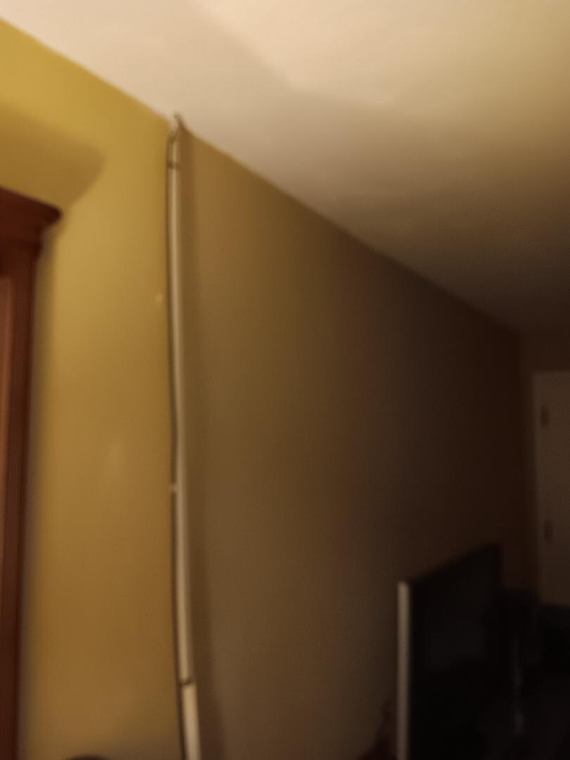 Cord cover just hanging and not attached to the wall.