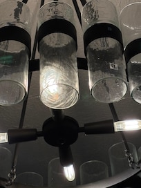 spiderwebs on the chandelier above the dinning table