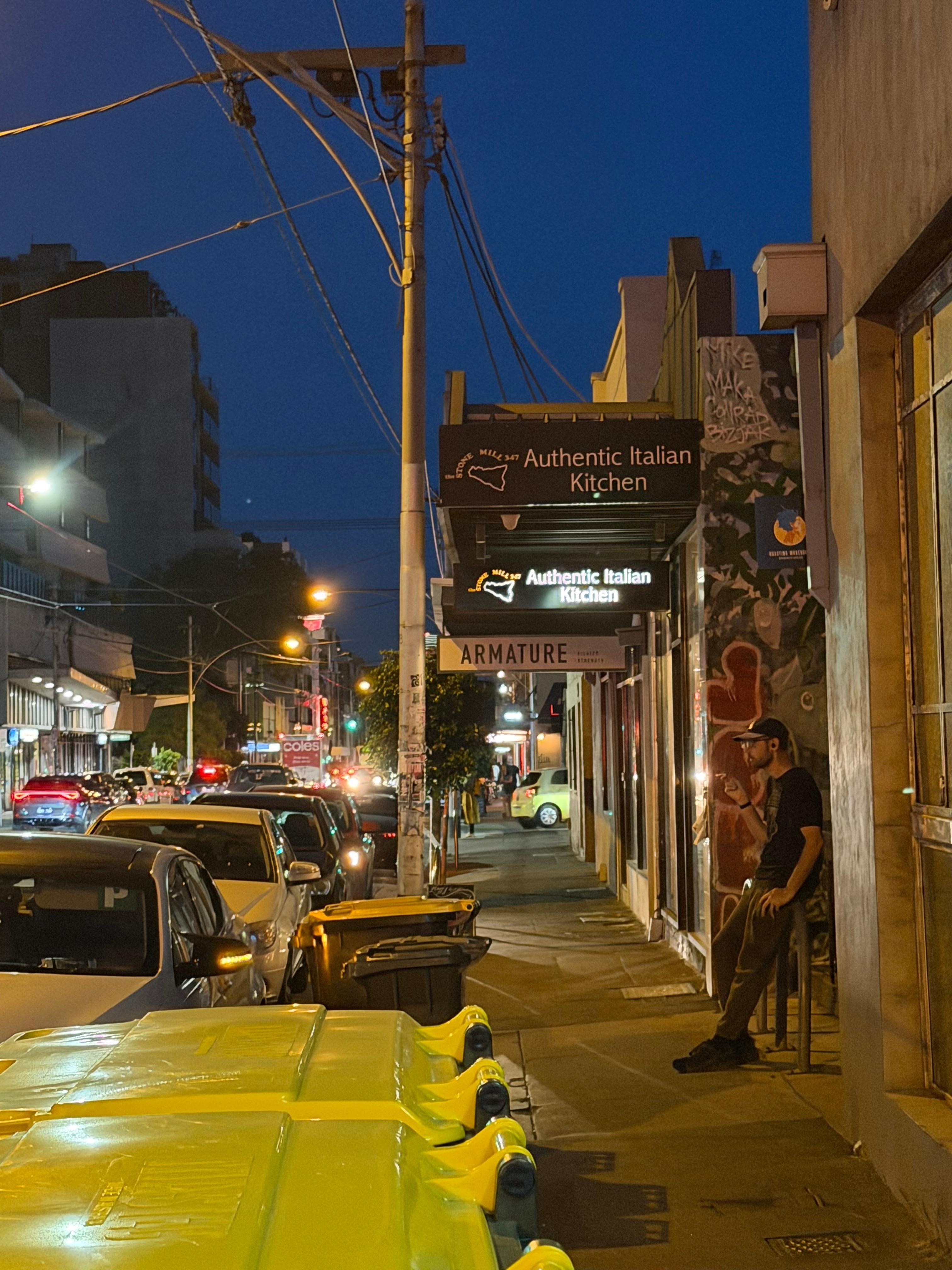 Lygon street at night near unit with great Italian restaurant