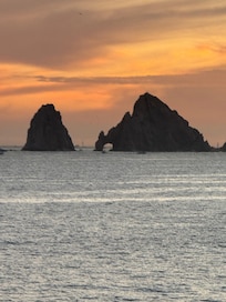 The famous arch at sunset viewed from the beach right near the property.