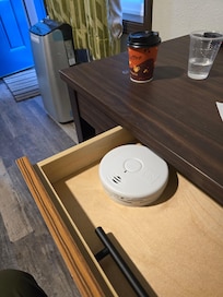 Smoke detector not installed in room, it was sitting in desk drawer! Fire code violation!