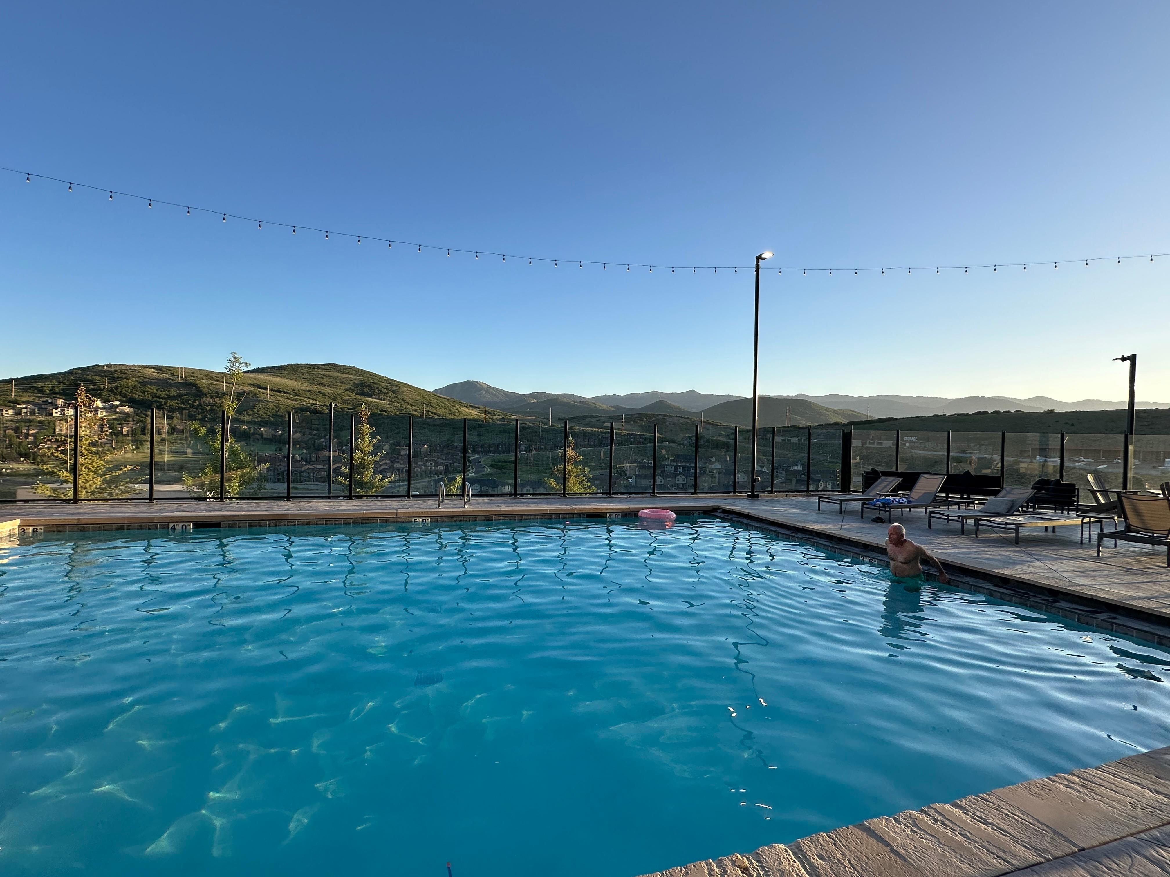 Poolside with hills in background.