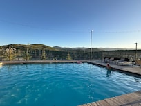 Poolside with hills in background.
