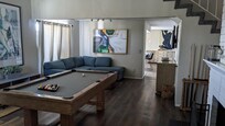 The living/game room with different furnishings.