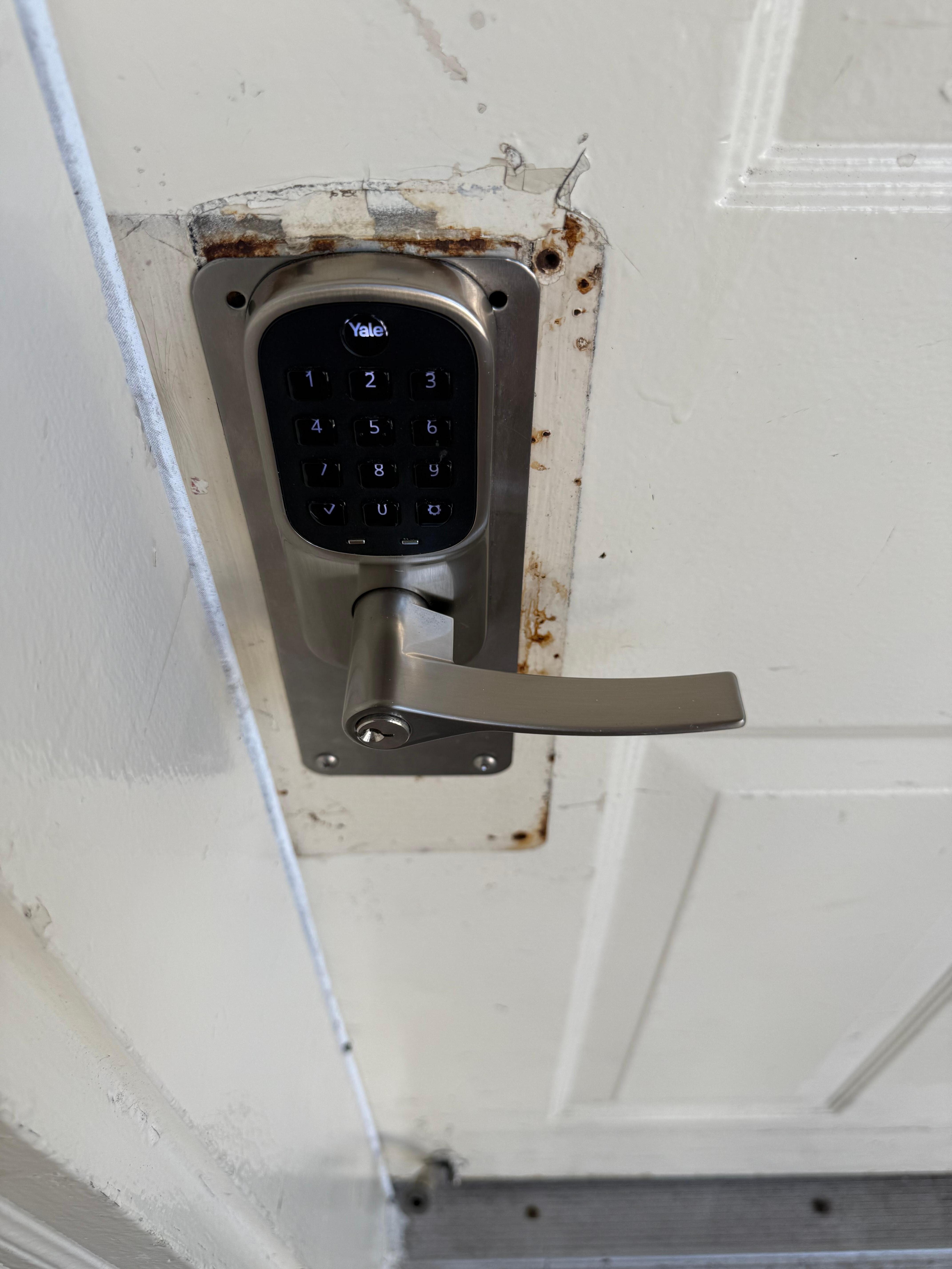 Outside of the door. Filthy. Press the handle and the plate moved.