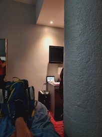 Sitting in bed watching half a tv.