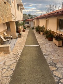 Walkway to rooms. Be on the lookout for the friendly cat!