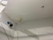 Stained an bowing bathroom ceiling