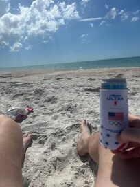 Relaxing at the beach with beach chairs and umbrella supplied.