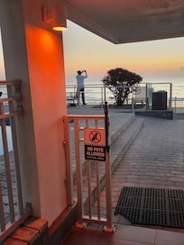 Desk clerk taking photos while guests looking for help
