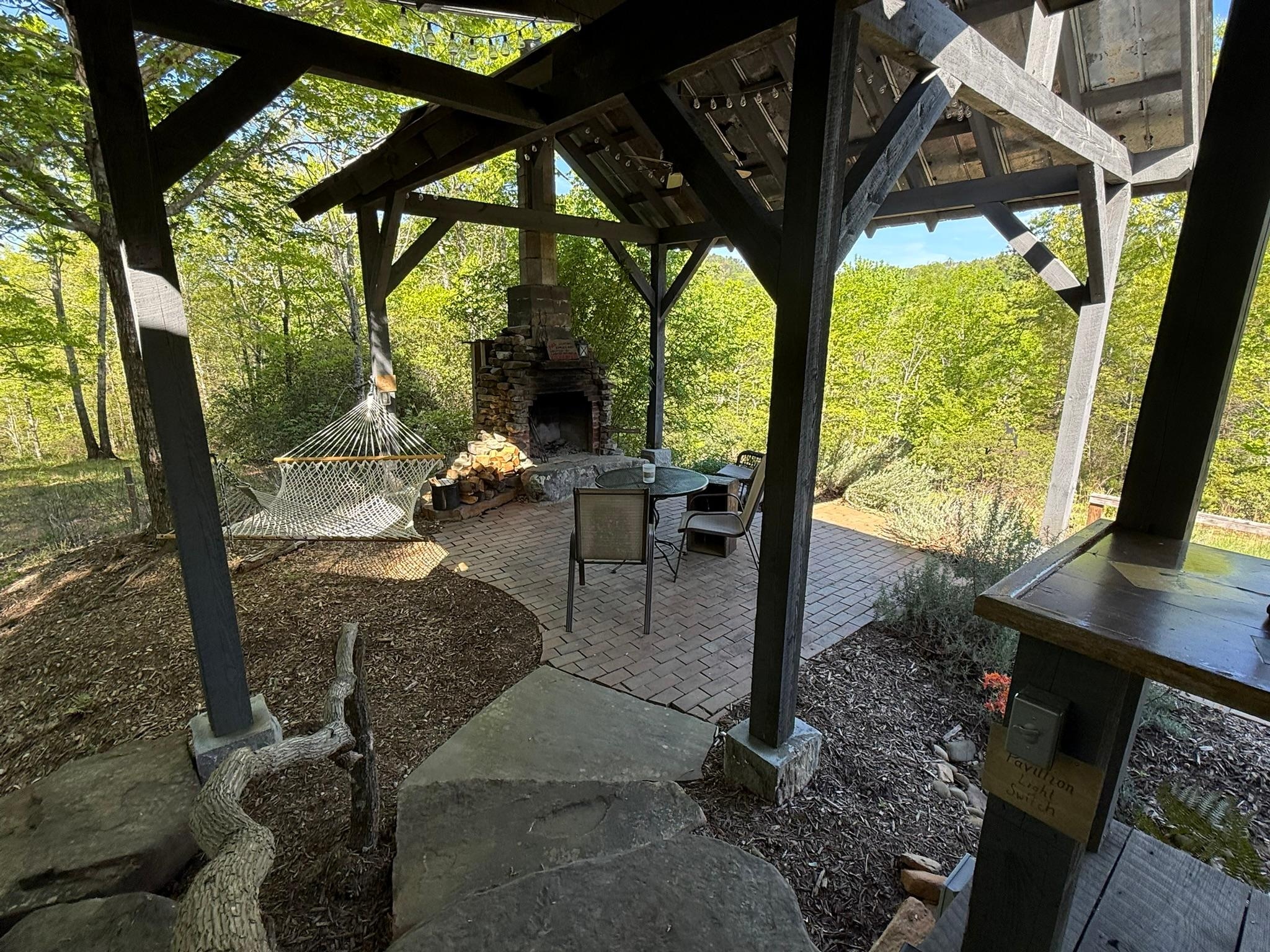 The view from the porch to the fireplace and hammock area.  