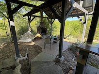 The view from the porch to the fireplace and hammock area.