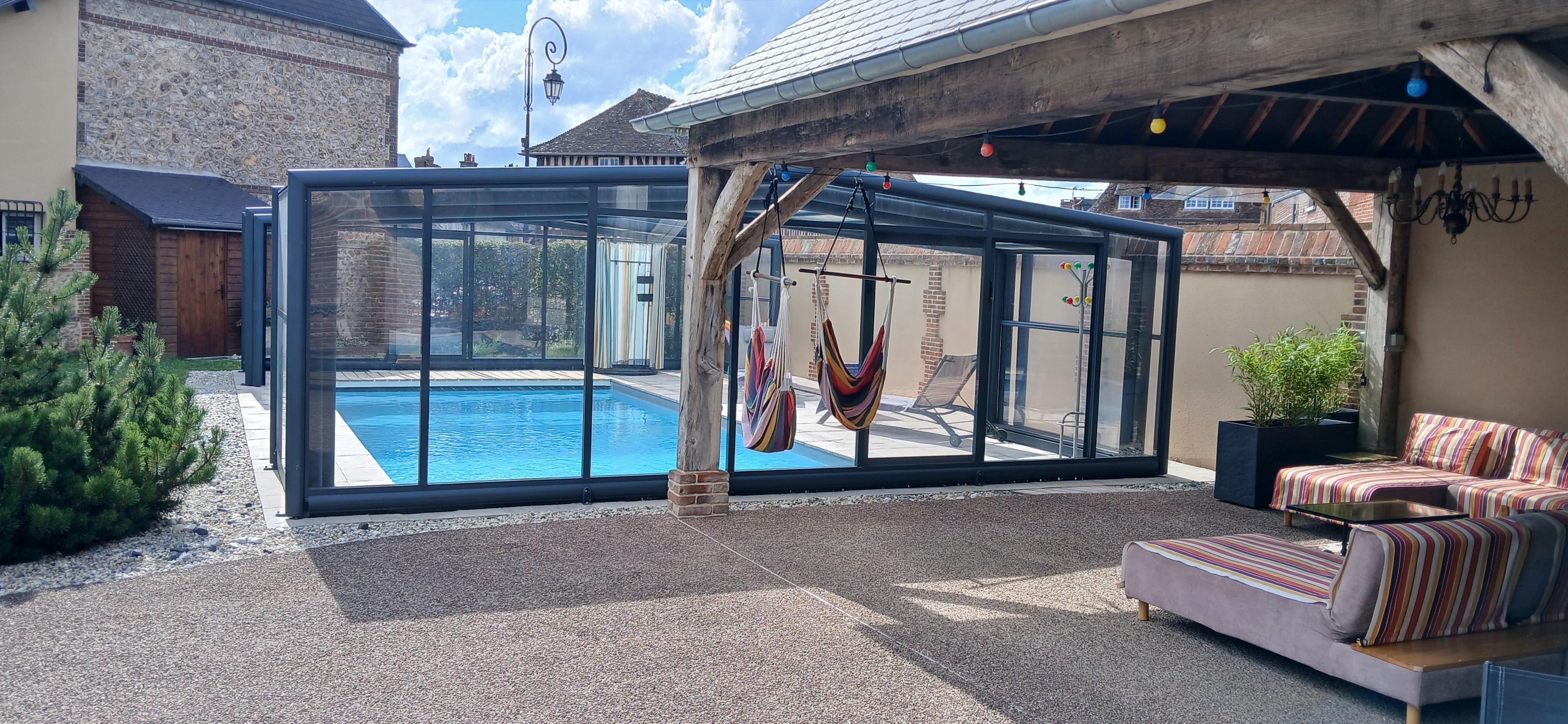Outside covered seating area and pool.