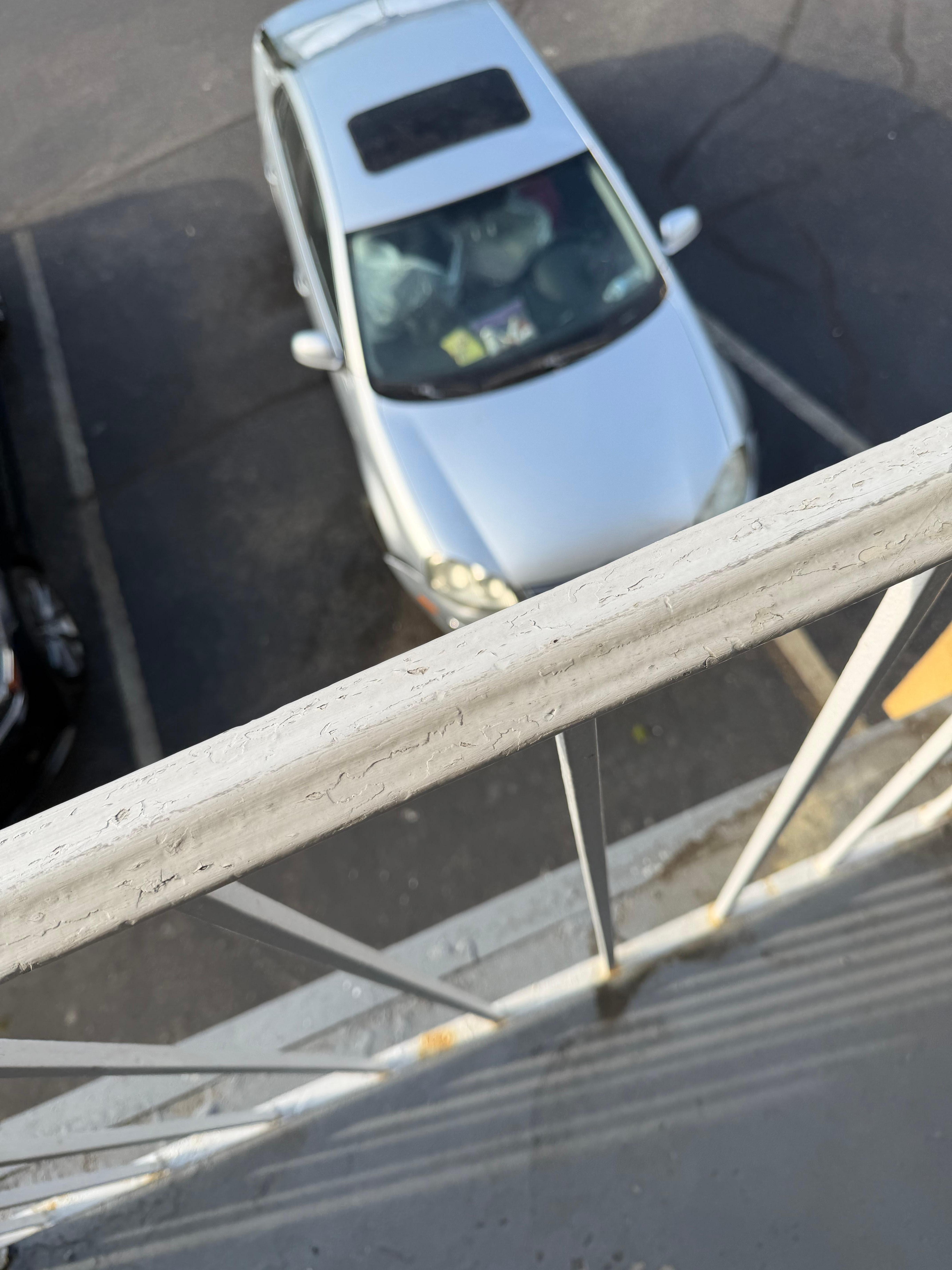 Phot of car broken down outside our room with pill bottles and trash piled up in it. Whole place has cars broken down on it 