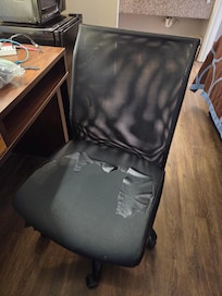 Desk chair with ripped and missing search cover