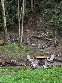 View of stream and fire pit from balcony