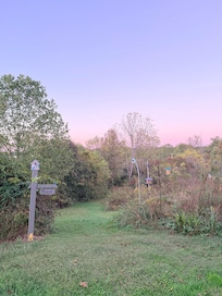 Trail just behind cabin leading to a pond, also beautiful fields visible from yard & windows