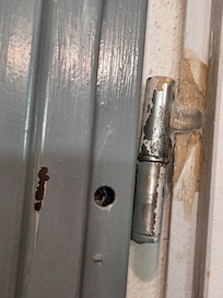 Glued on bathroom door hinge.