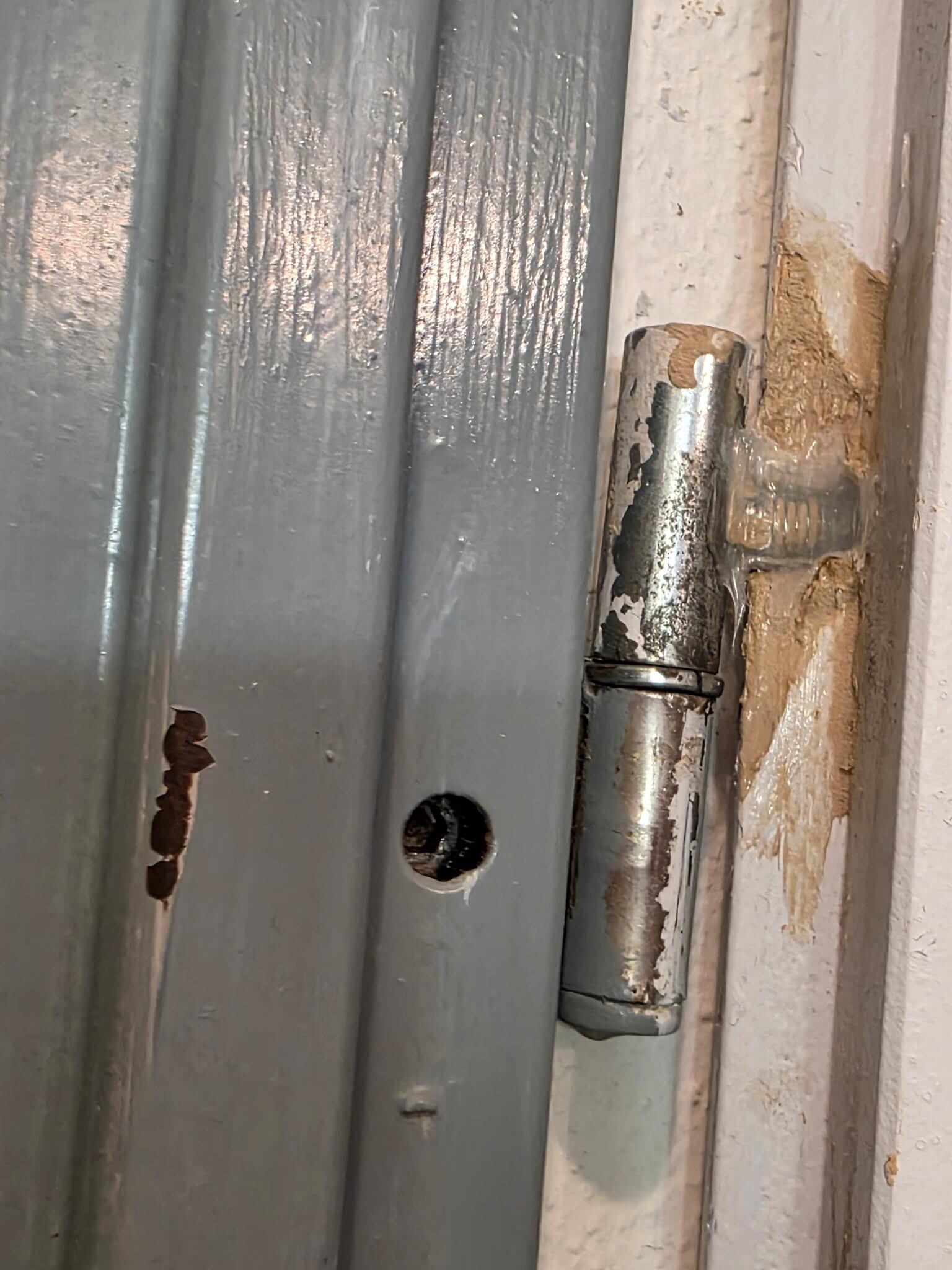 Glued on bathroom door hinge.