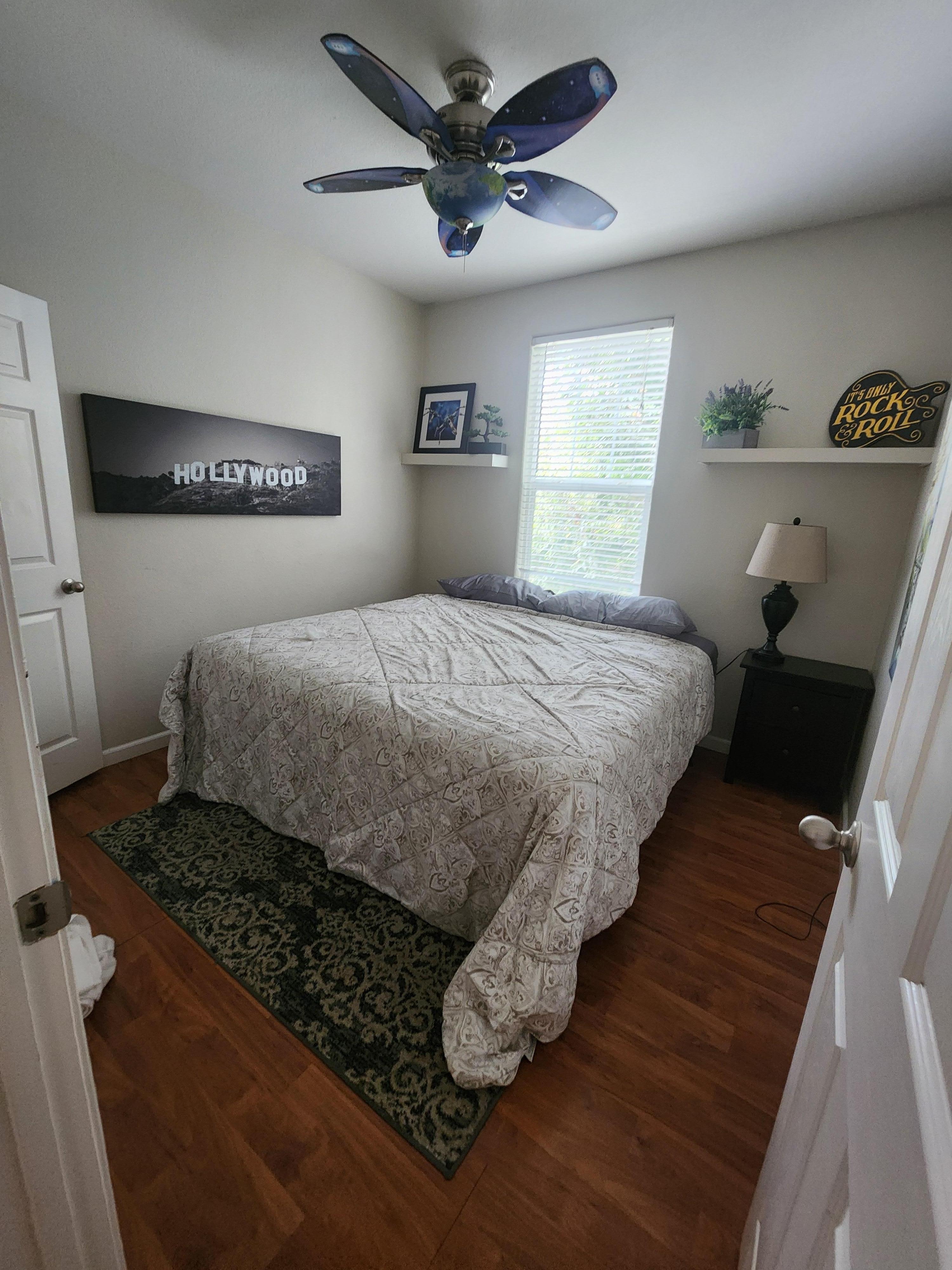 2nd bedroom with king bed with extra pillows and blankets