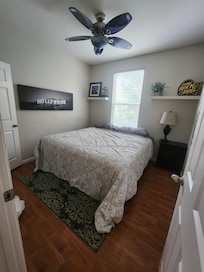 2nd bedroom with king bed with extra pillows and blankets