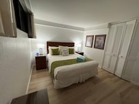 Primary bedroom has one regular dresser and two night stands with storage as well as a desk, chair and closet.