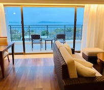Living room, kitchen and dining area, and balcony with sea and pool view