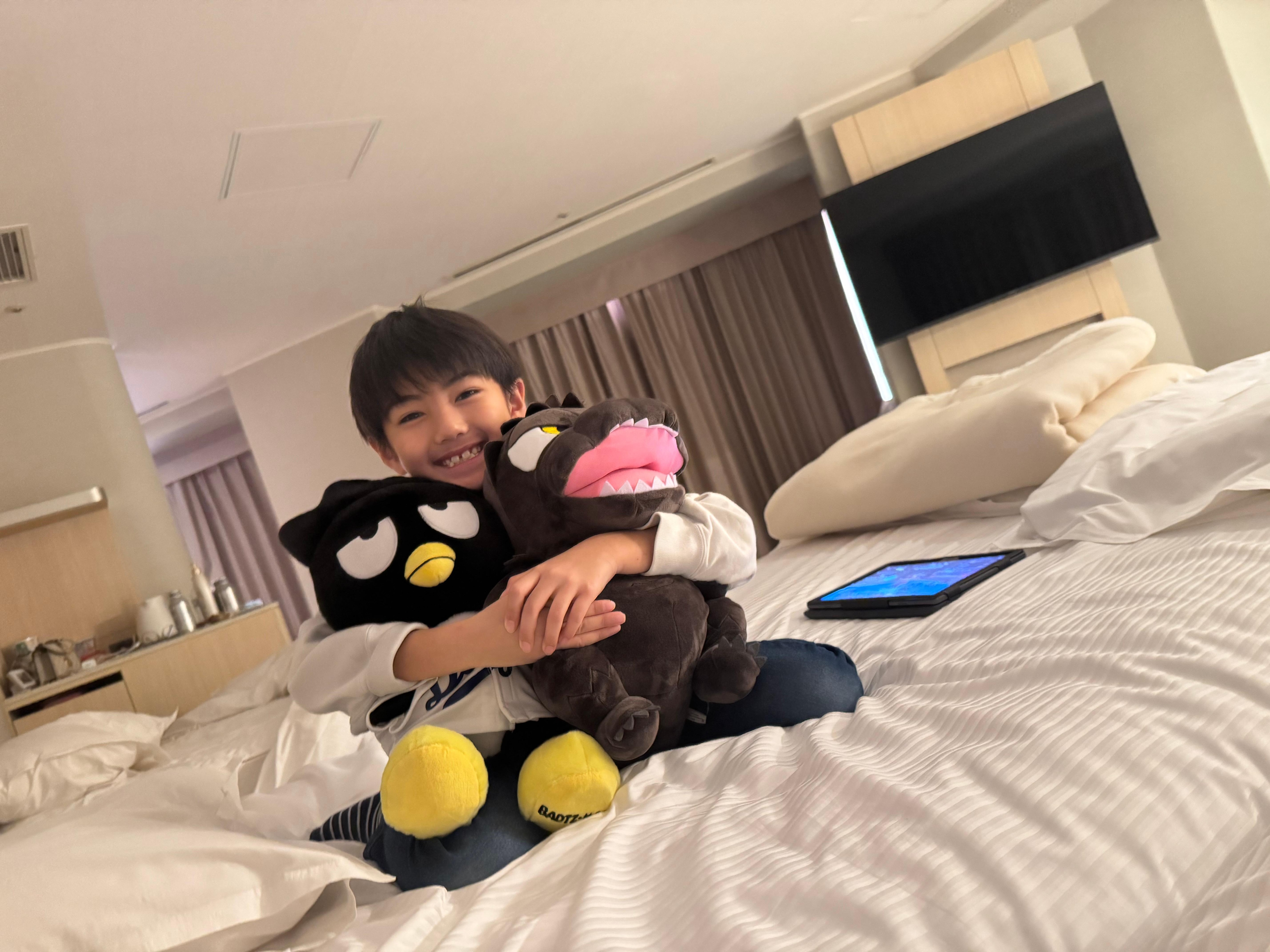 My grandson was comfortable on his bed.