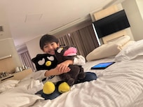 My grandson was comfortable on his bed.