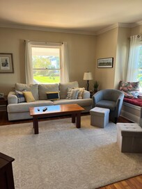 Spacious front living room with comfortable furniture and television- adjoins the foyer and the dining area. There is also a back sitting room with television and fireplace not photographed.