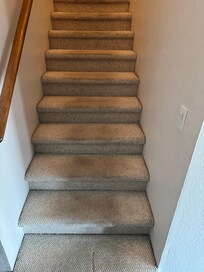 Dirty stairs going to upstairs bedrooms.