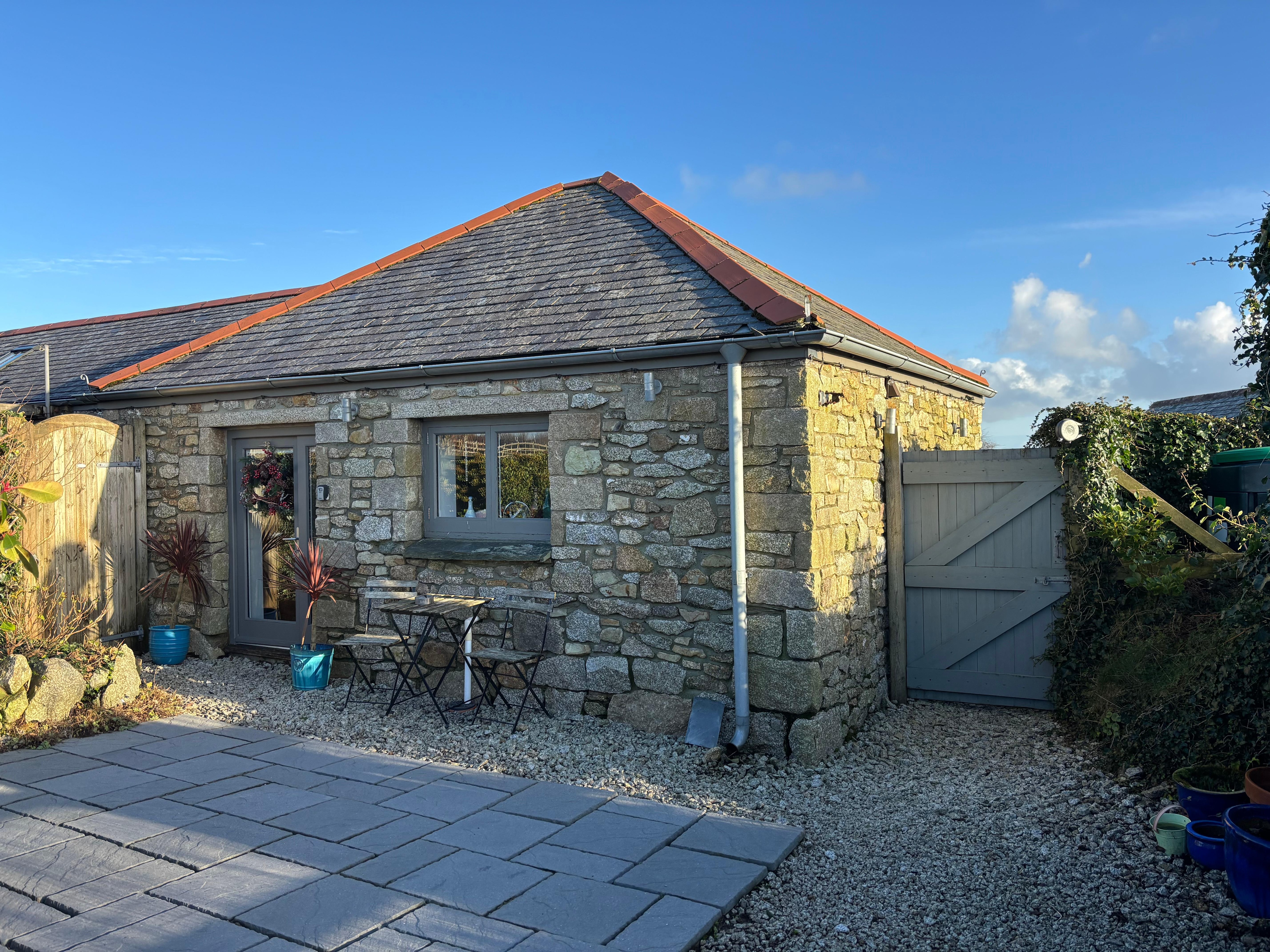 Rear view of patio showing kitchen window and living area