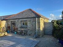 Rear view of patio showing kitchen window and living area