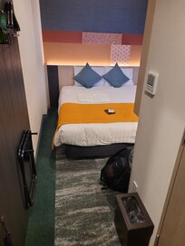 You can see my backpack at the foot of the bed barely fits between the bed and wall