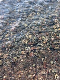 The water is SO CLEAN. Rocks are in the shallow but turns to sand just a little further in. I love this lake!