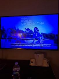 Both televisions in the room are showing blue. This one is the living room